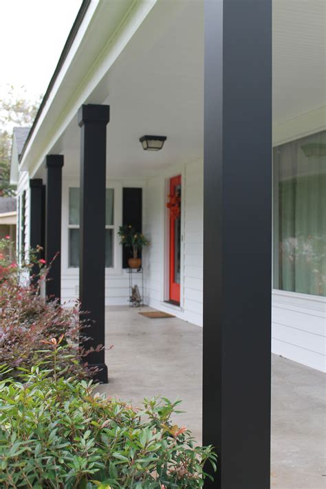 black steel porch column boxed in bases|cedar columns with black rails.